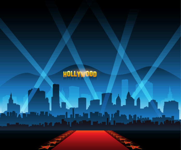 391241914 Hollywood skyline with red carpet and spotlights