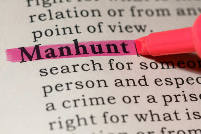 Pink highlighter marking word manhunt in book
