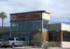 Guns and ammo store with parking lot.