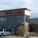 Guns and ammo store with parking lot.