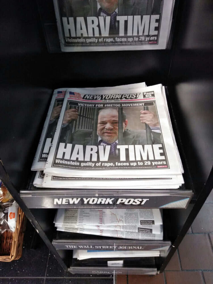 1656413044 Newspapers on rack with headline about trial verdict