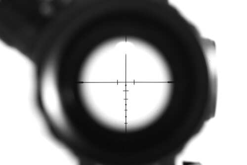 shutterstock_1112583581.jpg Close-up view of a rifle scope's crosshair