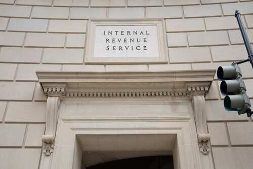 Entrance of the Internal Revenue Service building with a prominent sign