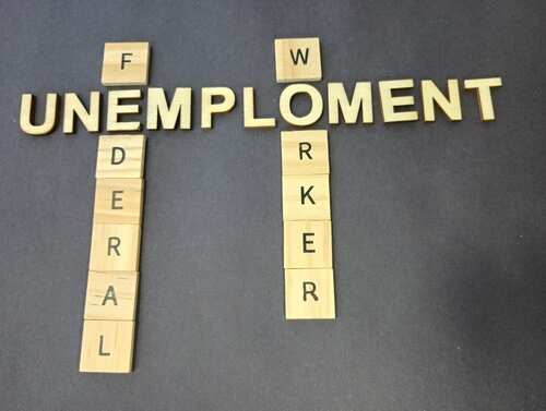 shutterstock_2586943219.jpg Wooden letter tiles spelling 'UNEMPLOYMENT' and 'FEDERAL WORKER'