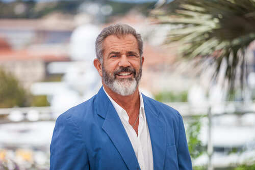 shutterstock_425822317.jpg Smiling man in a blue blazer standing outdoors