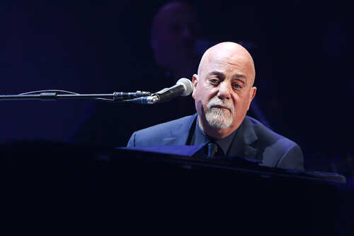 A musician performing at a piano during a concert