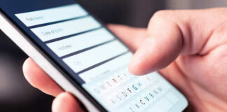 Close-up of a hand using a smartphone to enter information