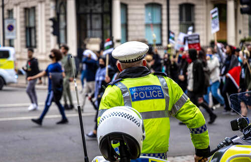 shutterstock_1974044105.jpg Metropolitan police officer monitoring a protest
