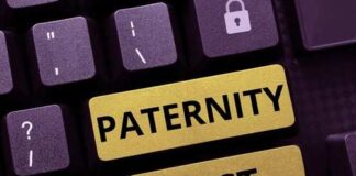 Close-up of a keyboard with keys labeled 'PATERNITY' and 'TEST'