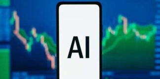 Smartphone displaying the text 'AI' in front of financial graphs