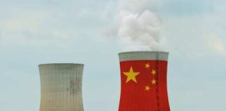 Cooling towers with the Chinese flag design and smoke rising