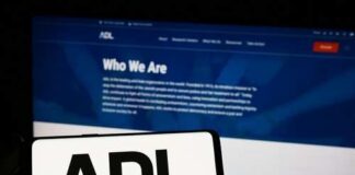 Mobile phone displaying the ADL logo in front of a website