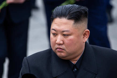A political figure in formal attire with a contemplative expression
