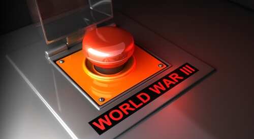 shutterstock_2257461615.jpg A large red button labeled 'WORLD WAR III' under a transparent cover