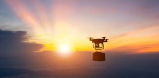 Drone flying against a sunset backdrop carrying a package
