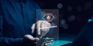A person interacting with a digital screen displaying a sensitive content warning