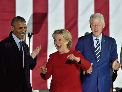 Three public figures smiling and engaging at a political event