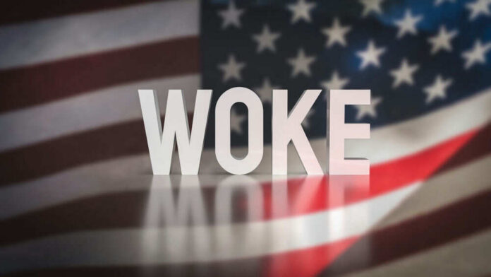 2281088601 WOKE text over blurred American flag background.