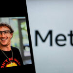 Smiling man wearing glasses near Meta logo