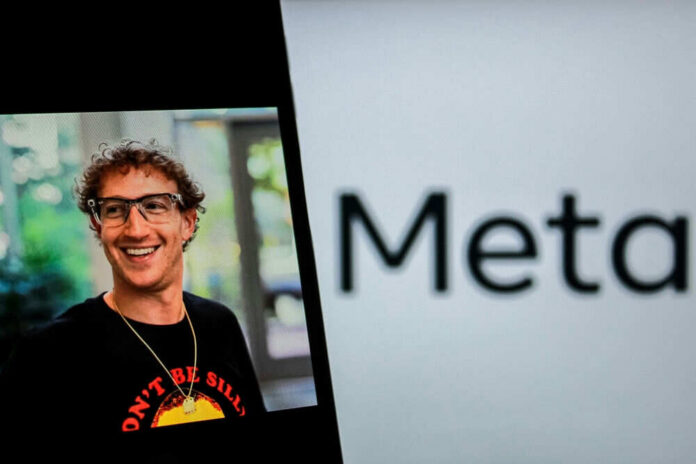 Smiling man wearing glasses near Meta logo