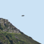 Pentagon UFO Files—Decades of Cover-Up EXPOSED A UFO hovering above a mountain landscape