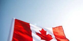 Waving Canadian flag against a clear sky