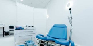 A blue medical examination chair in a sterile healthcare room