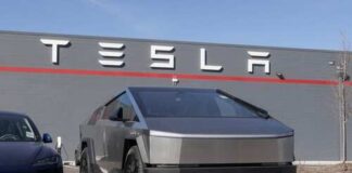Tesla Cybertruck parked in front of a Tesla building