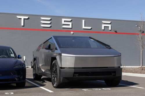 Tesla Cybertruck parked in front of a Tesla building