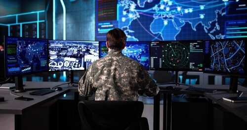 shutterstock_2688701059.jpg Military personnel monitoring multiple screens in a command center