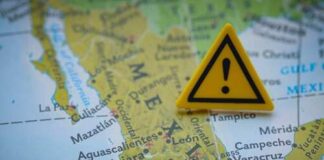 A yellow warning sign placed on a map of Mexico