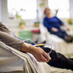 Patient receiving IV therapy in a hospital room