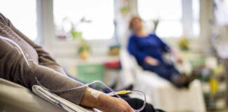 Patient receiving IV therapy in a hospital room