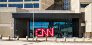 CNN headquarters building entrance with logo displayed.