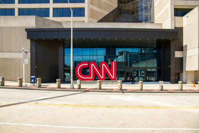 CNN headquarters building entrance with logo displayed.