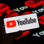 Trump’s SHOCKING Pick for Office—A YouTuber?! Hand holding phone showing YouTube logo.