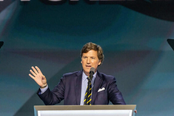 Man speaking at podium with microphone and gesturing