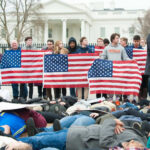 Illegal Immigrant’s Release: Fatal Consequences Group of young protesters holding American flags in front of the White House