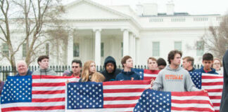 Group of young protesters holding American flags in front of the White House