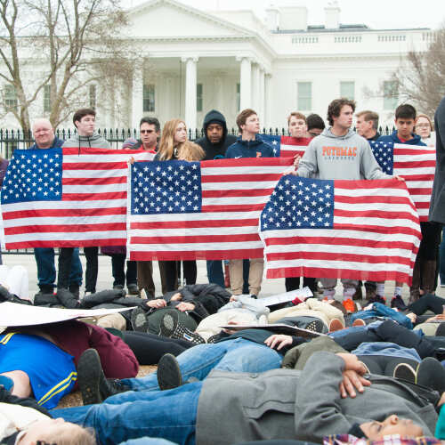 Group of young protesters holding American flags in front of the White House