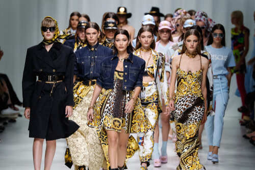 Models walking down the runway showcasing designer outfits