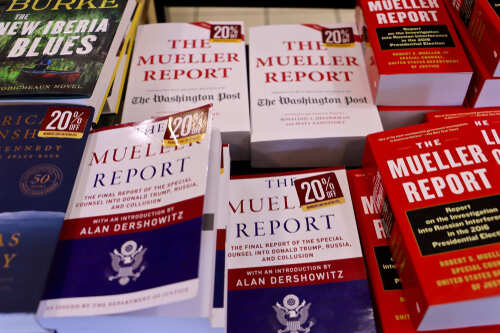 shutterstock_1403023064.jpg Display of multiple copies of The Mueller Report with discount tags