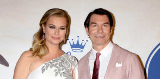 A couple posing together at a formal event on the red carpet