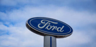 Ford logo on a sign against a cloudy sky