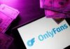 OnlyFans logo displayed on a tablet surrounded by cash