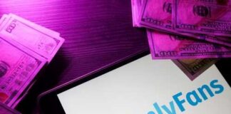 OnlyFans logo displayed on a tablet surrounded by cash