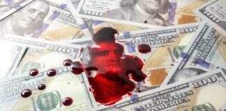 A pool of blood on a background of hundred dollar bills