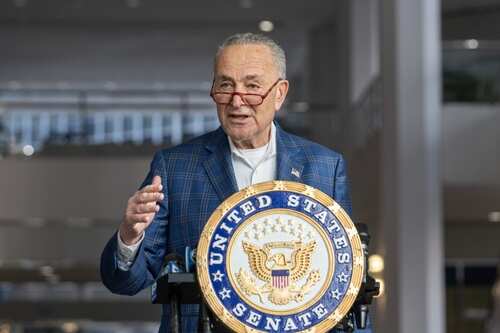 A government official speaking at a podium with the United States Senate seal
