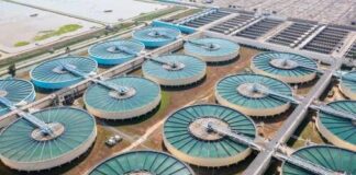 Aerial view of a large water treatment facility with circular tanks