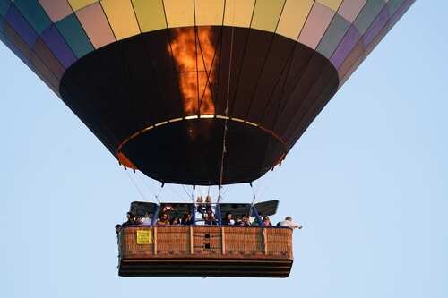 Passengers in a hot air balloon enjoying a scenic flight